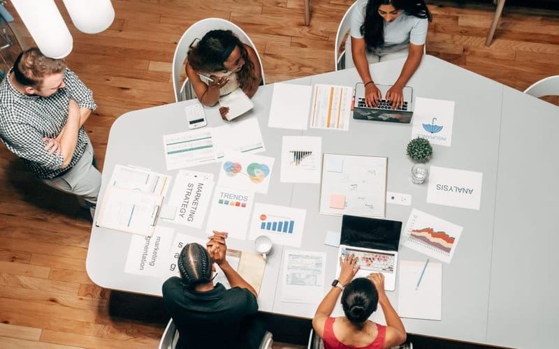 Marketing team reviewing SEO and analytics reports around a table